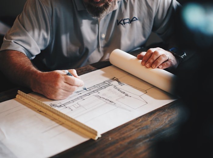 Architectural drawings being marked up at a desk