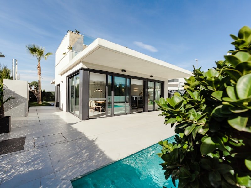 Modern white rendered villa with landscaped pool terrace